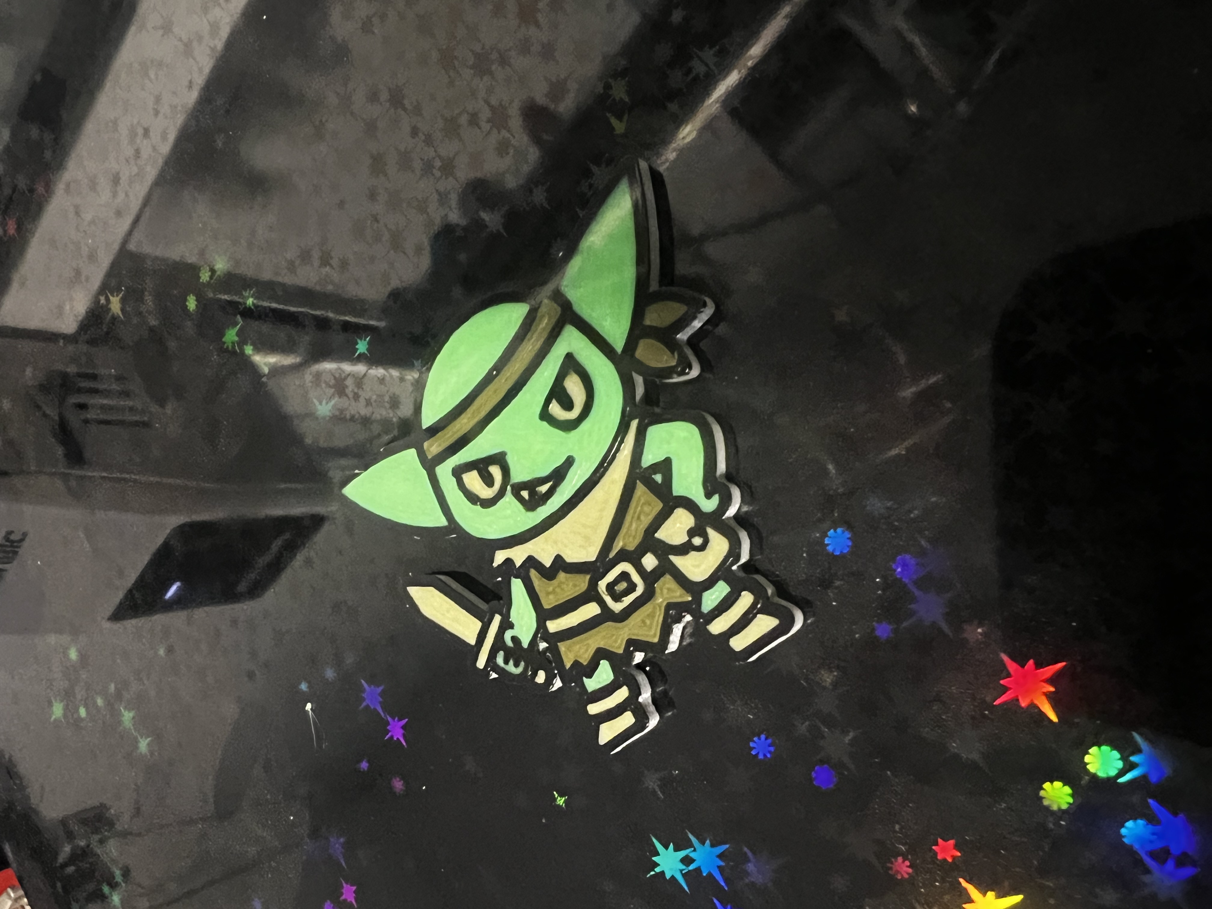 Finished multi-color character print resting on a 3D printer build plate